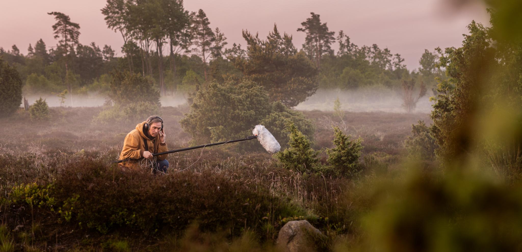A man with a microphone in a field