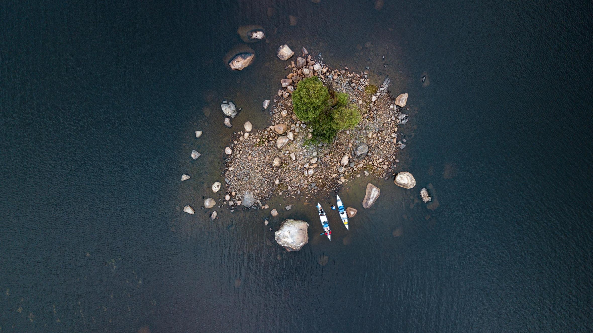 A top view of canoes docked on small island 