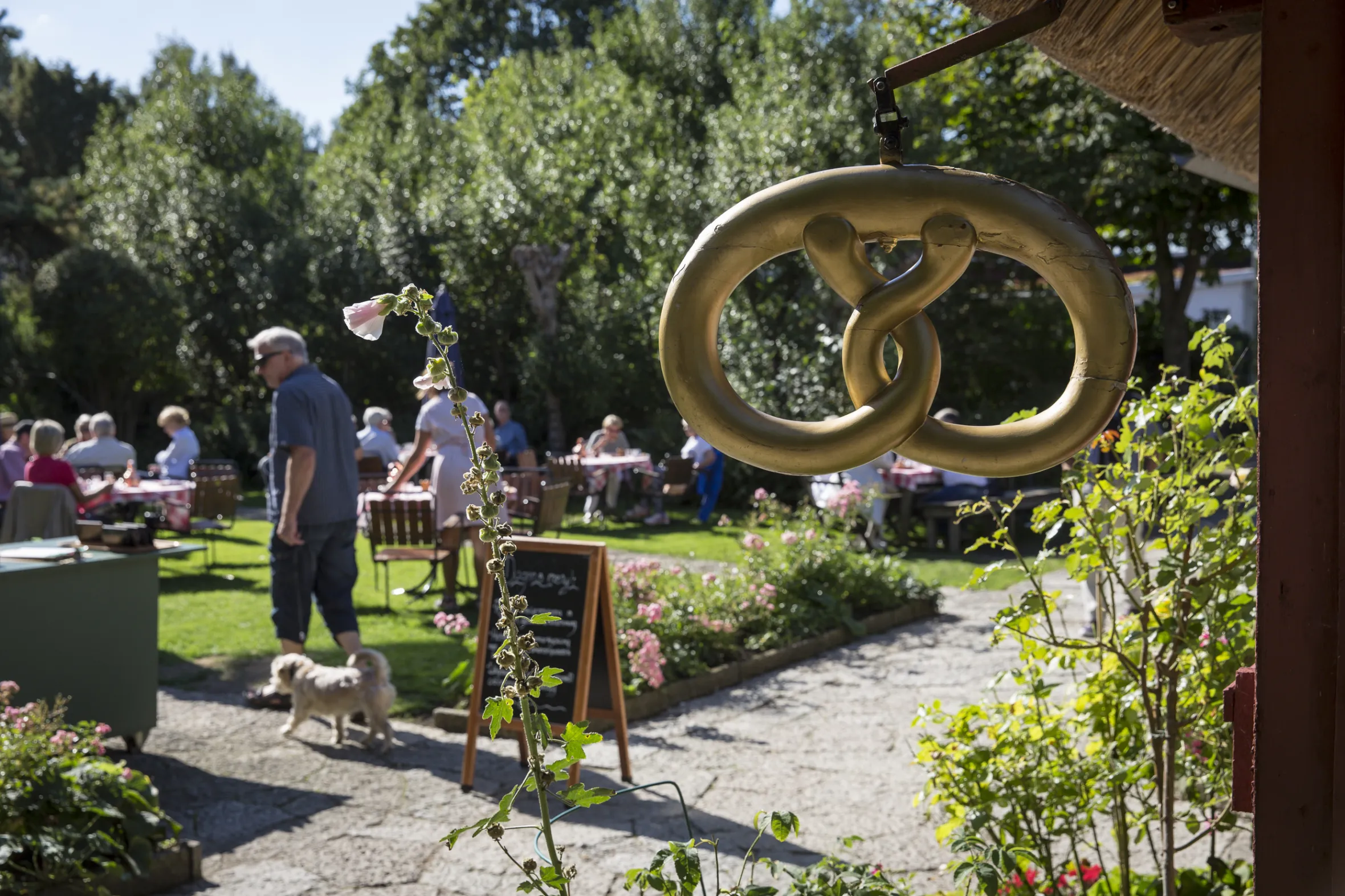 Gold petzel symbol with garden café backdrop