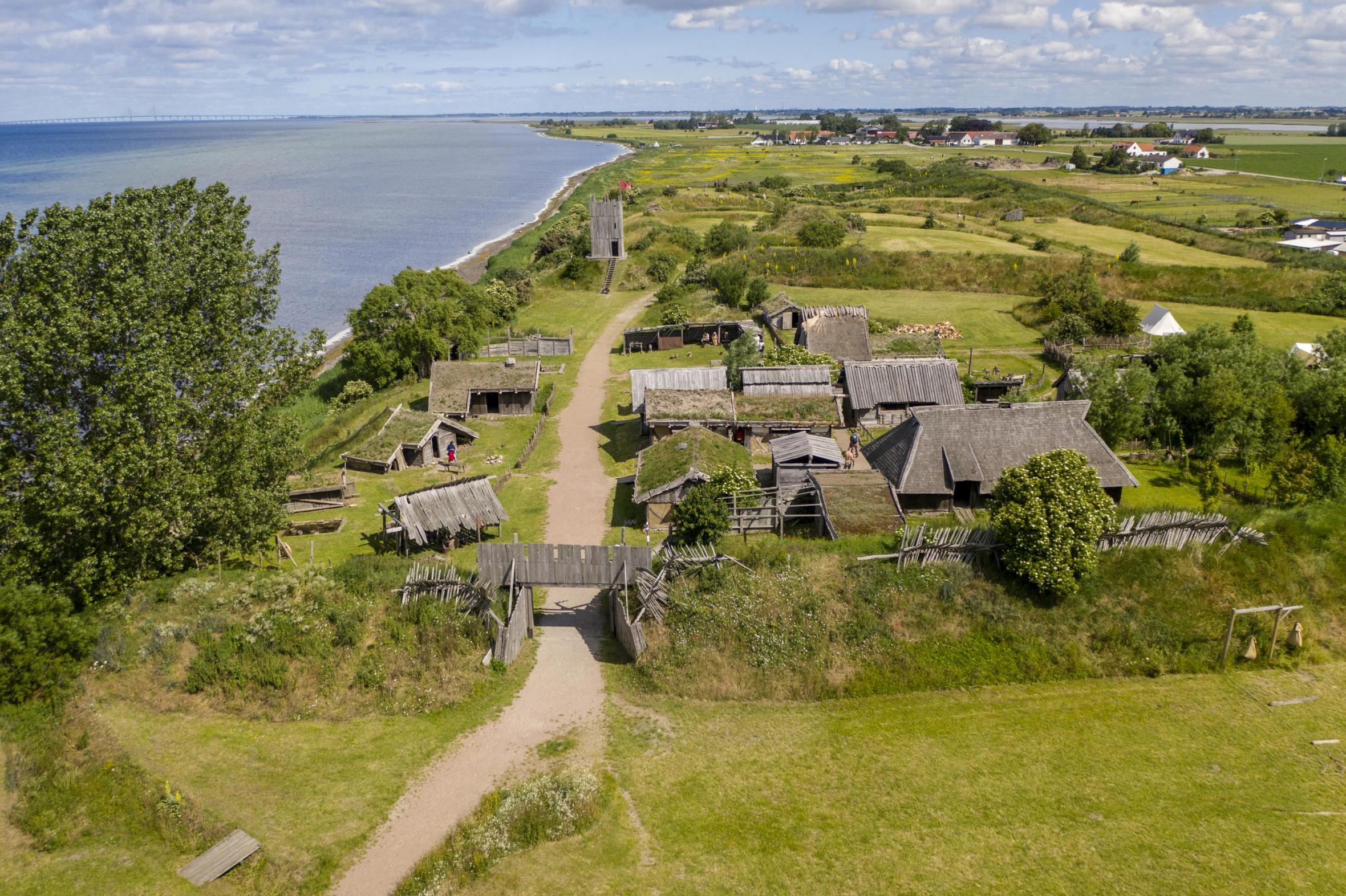 Foteviken viking village with green fields and sea in the background