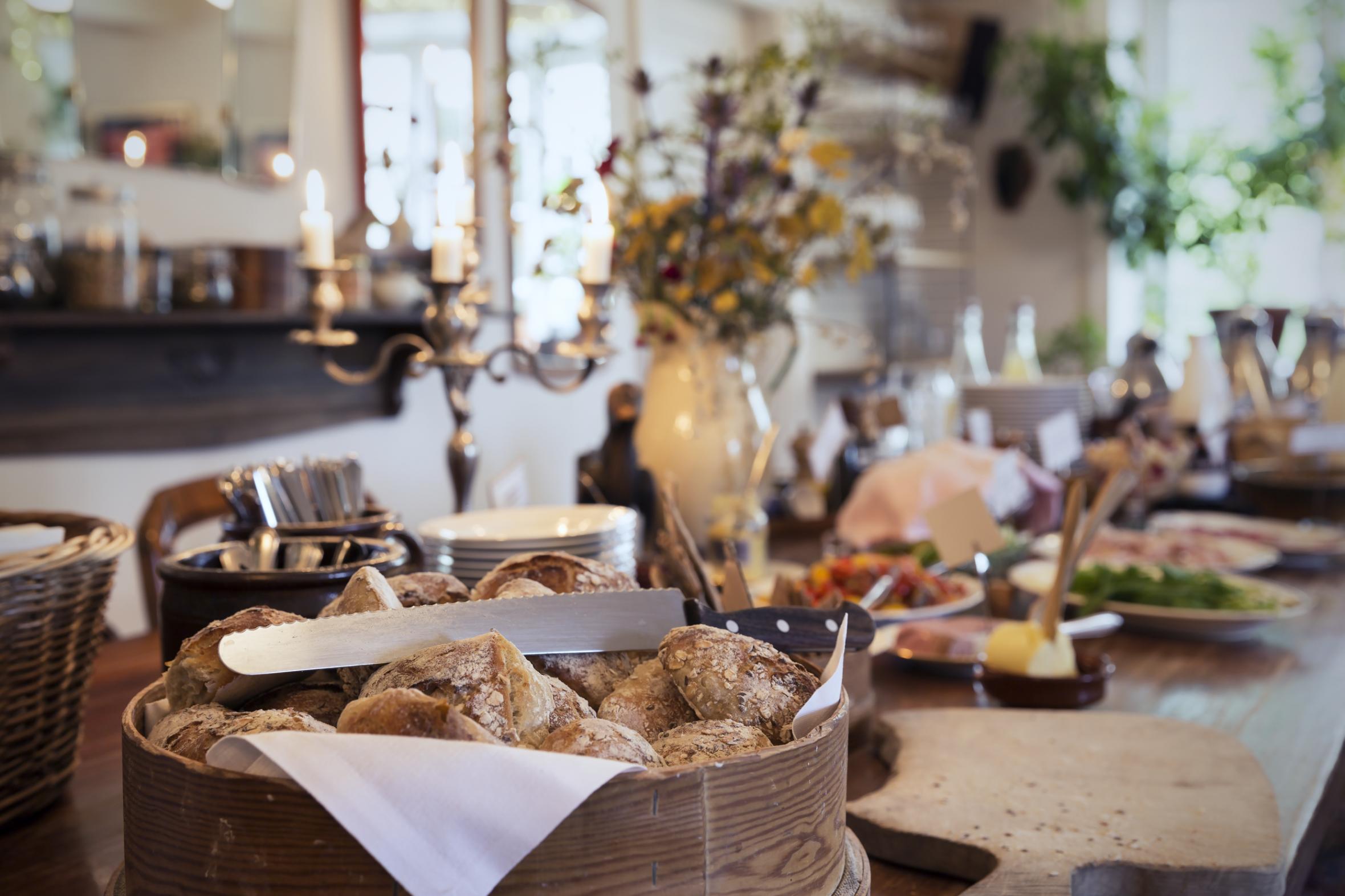 Breakfast buffet at hotel with candles and tablecloth