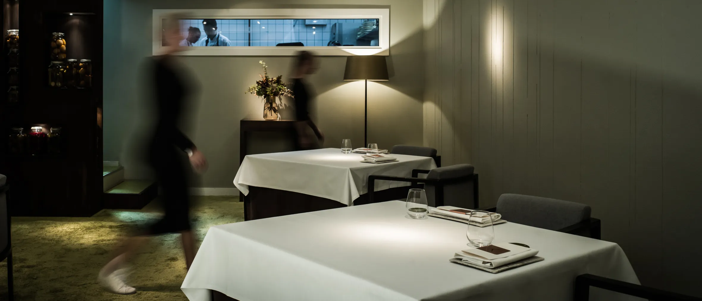Tables with white cloths in an exklusive restaurant atmosphere