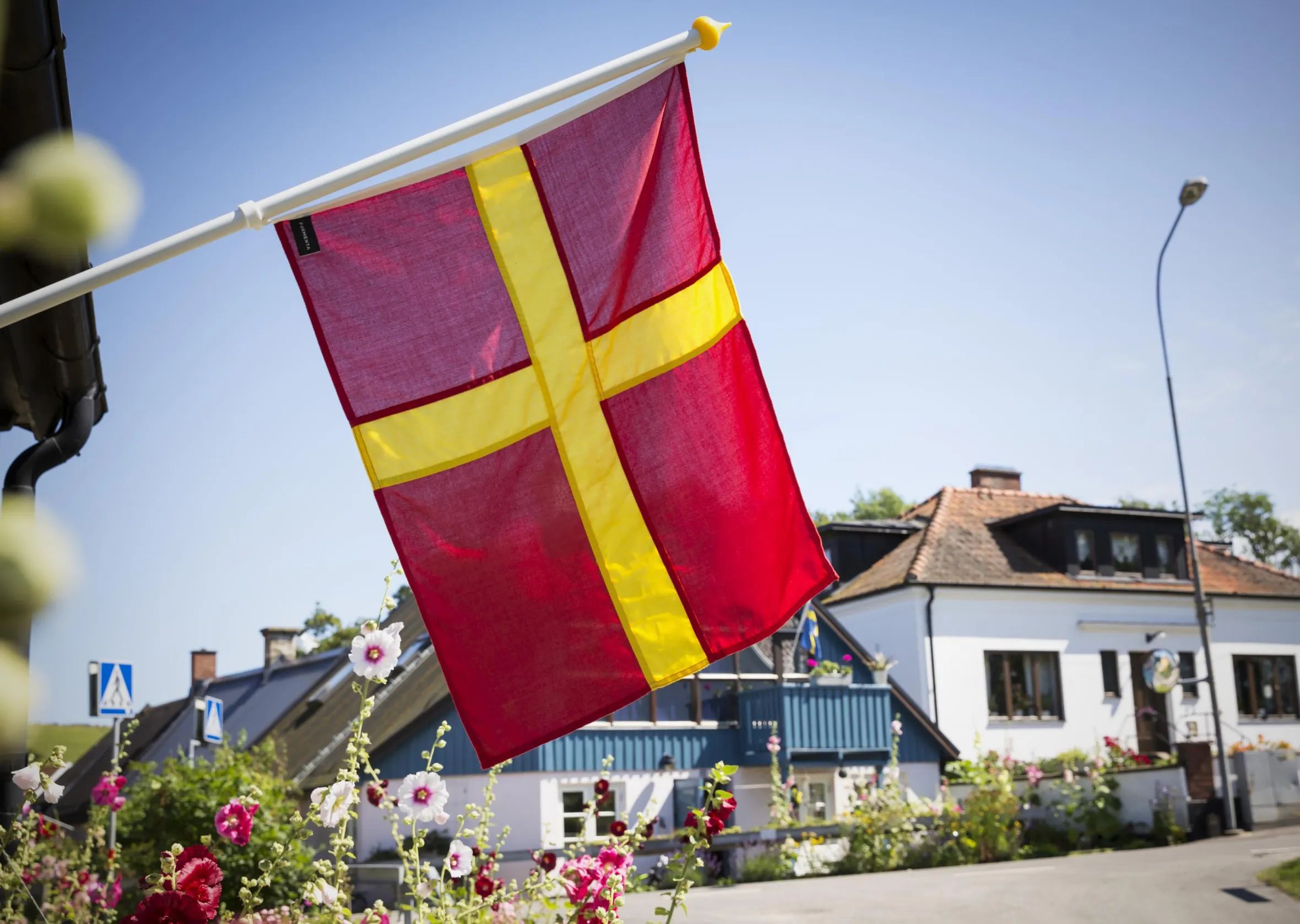 The Skåne flag handing in front of a house