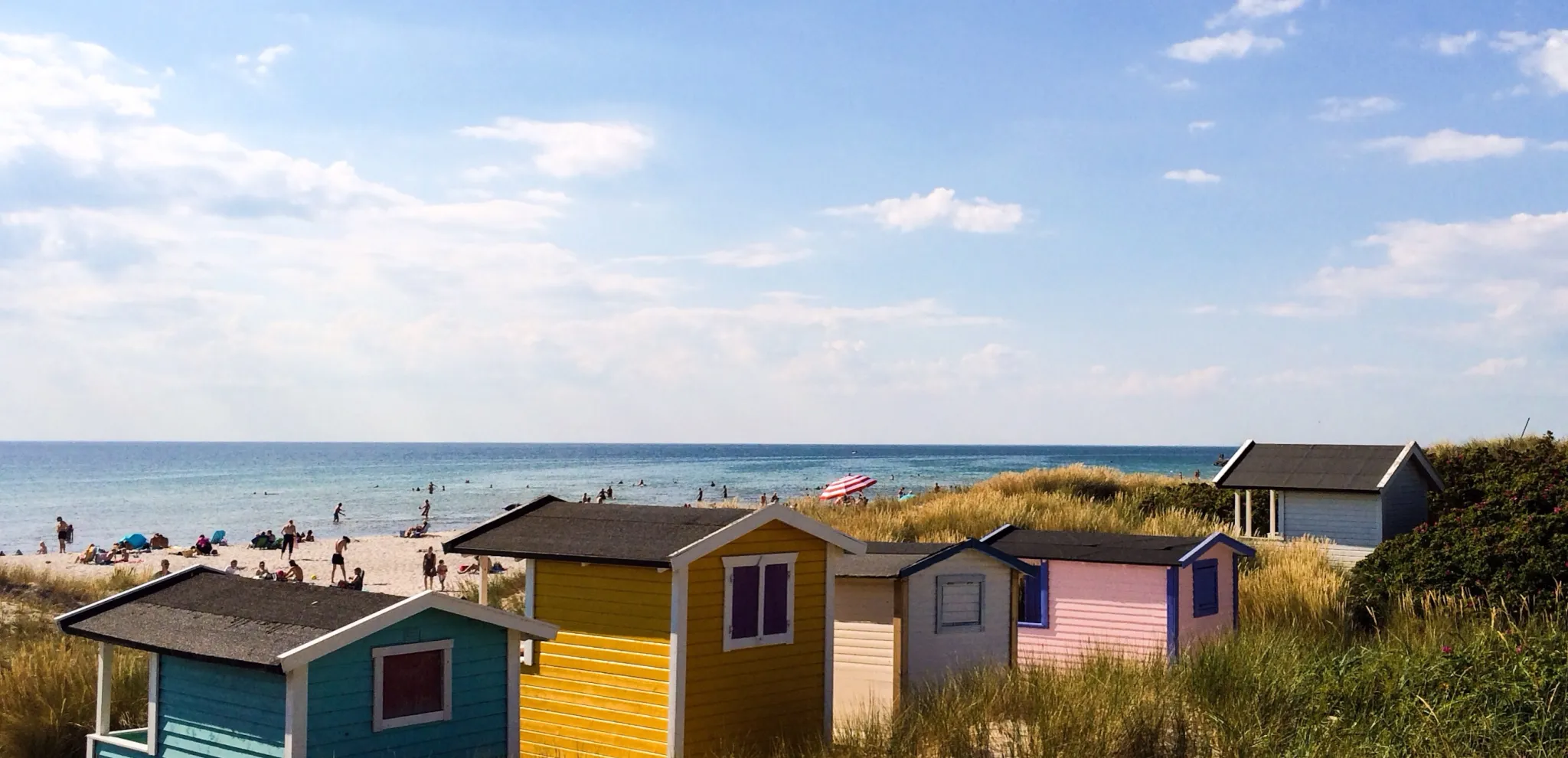 Colourful bathing huts along a beach
