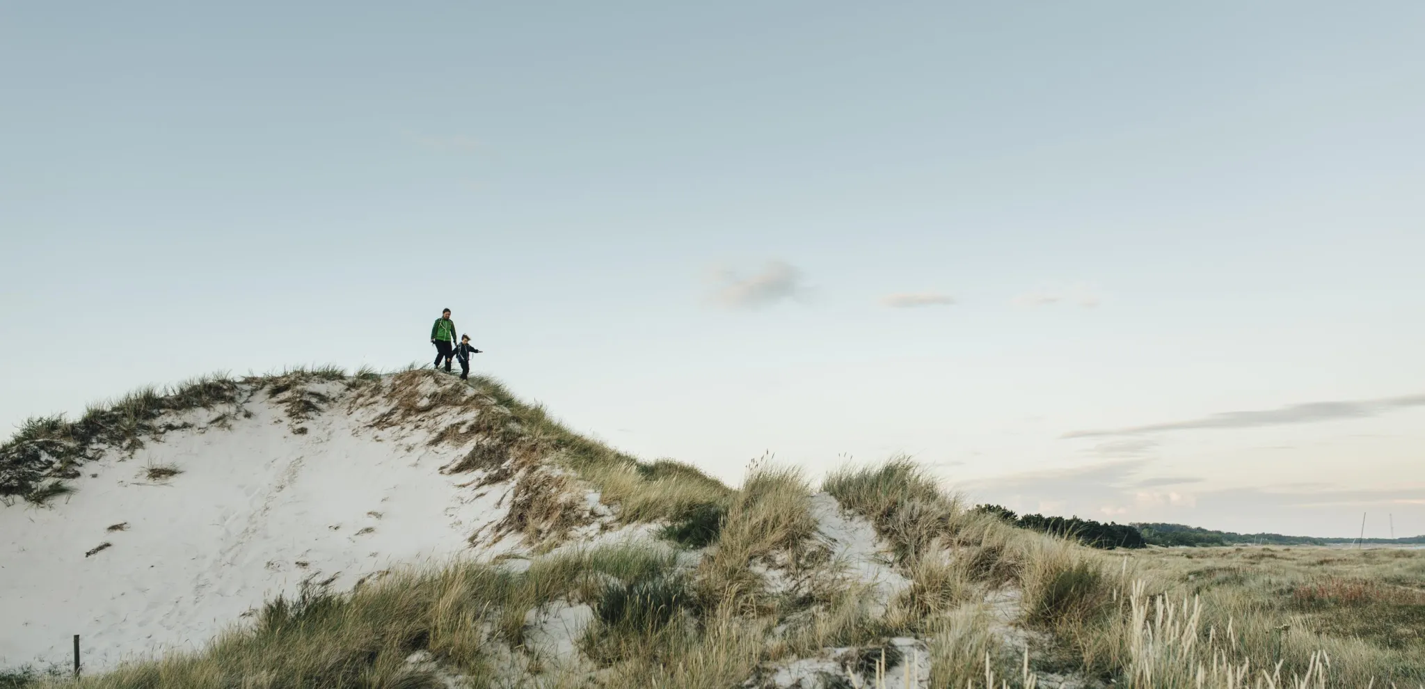 Mom and son walking on the sand dunes of Måkläppen