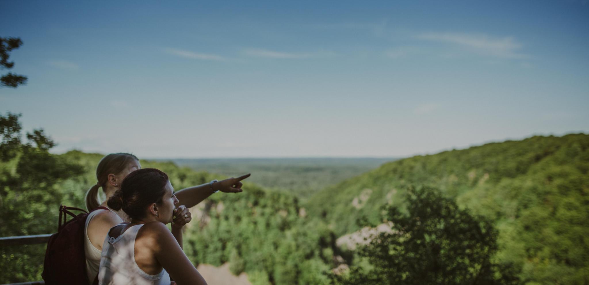 Couple pointing at the view of a nature reserve