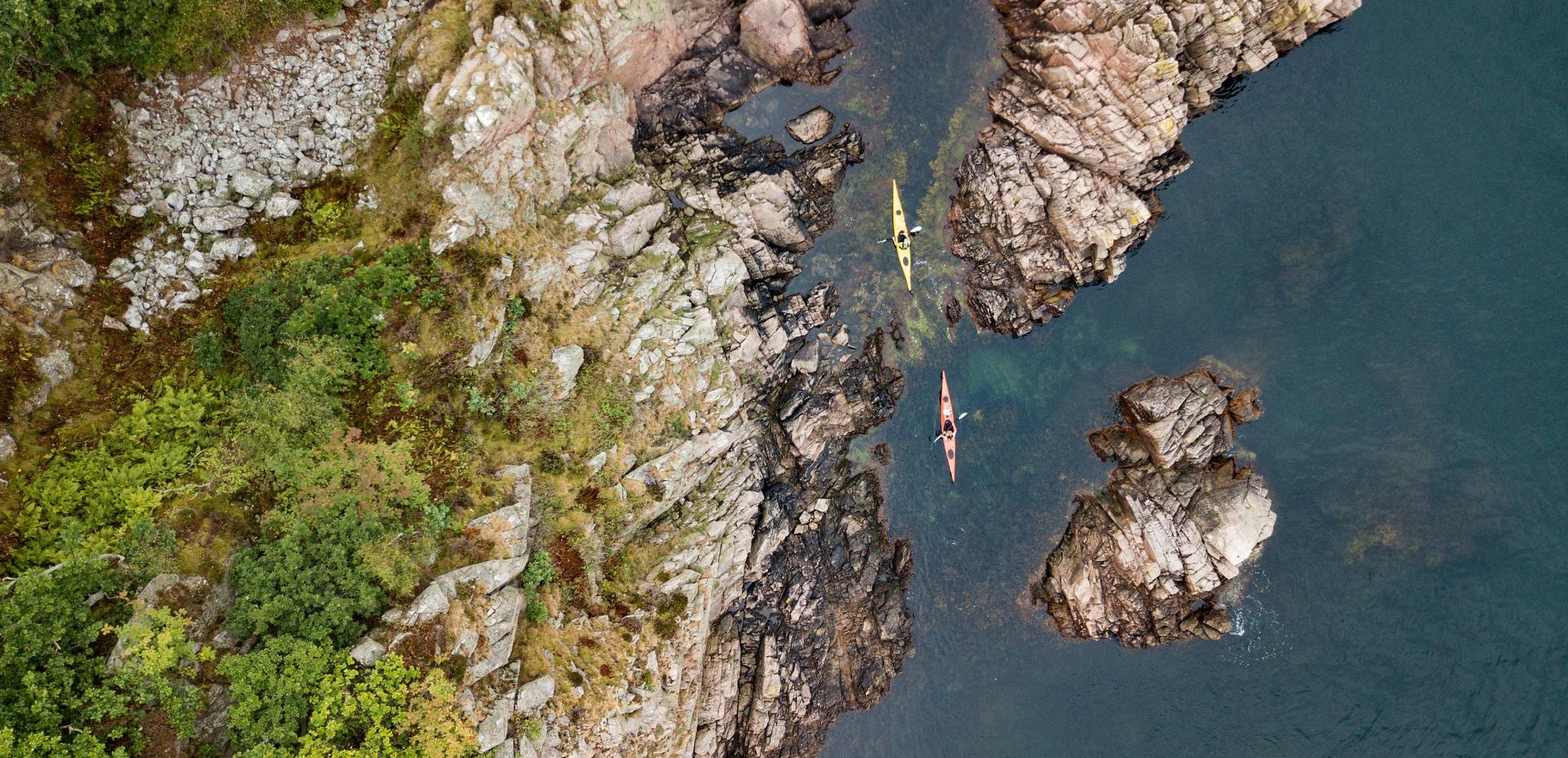 View from above of a canoe docking in archipelago at Kullaberg