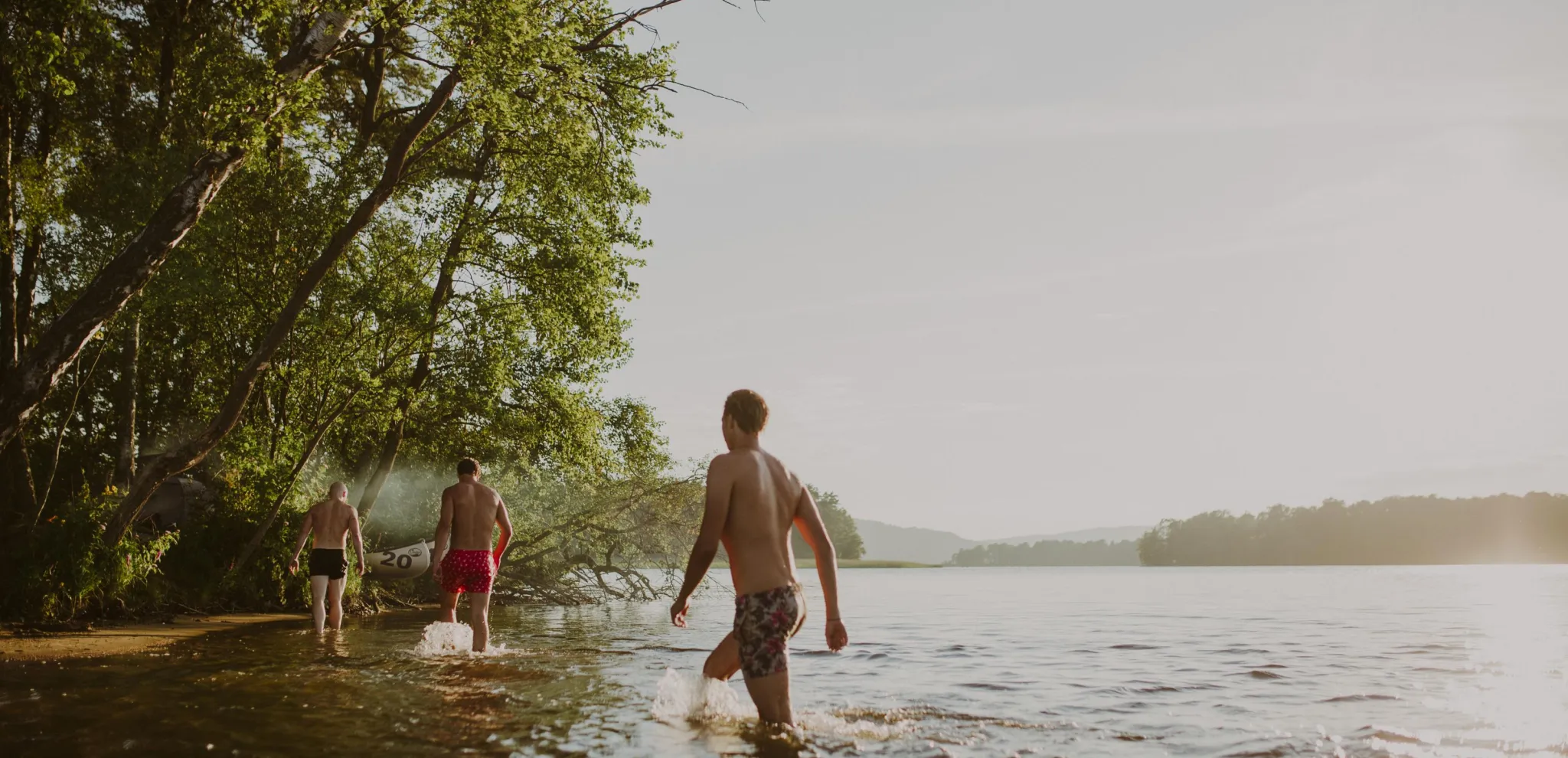 Three friends take an evening dip in Ivösjön