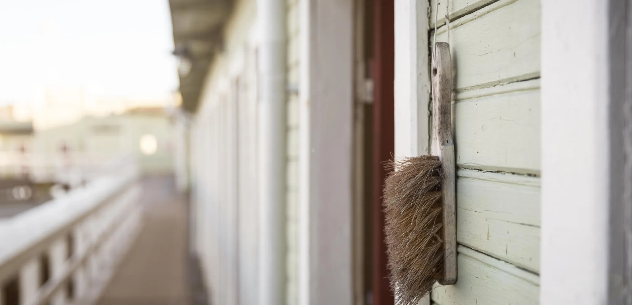 Brush haning on wall in open-air bathhouse