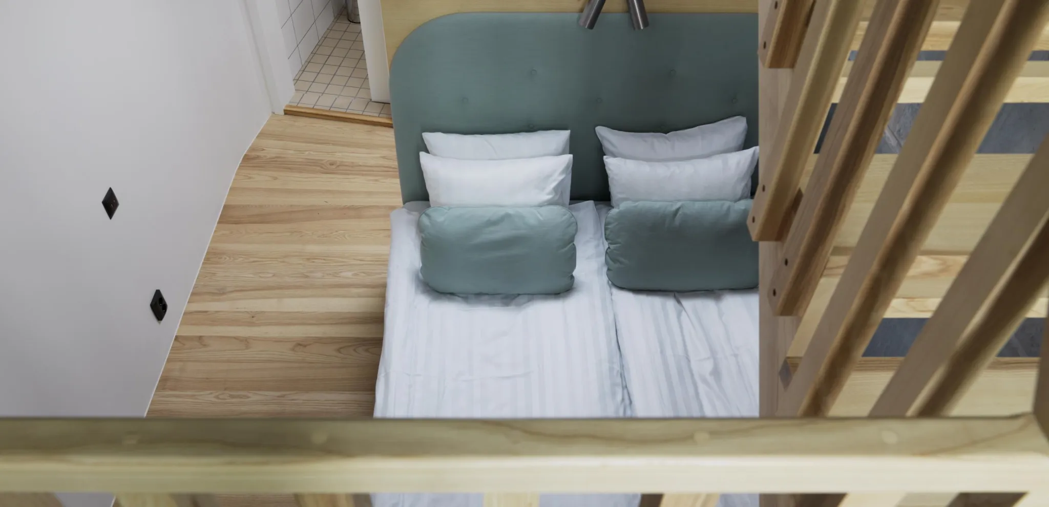 View of a bed and a wooden staircase from a second floor 