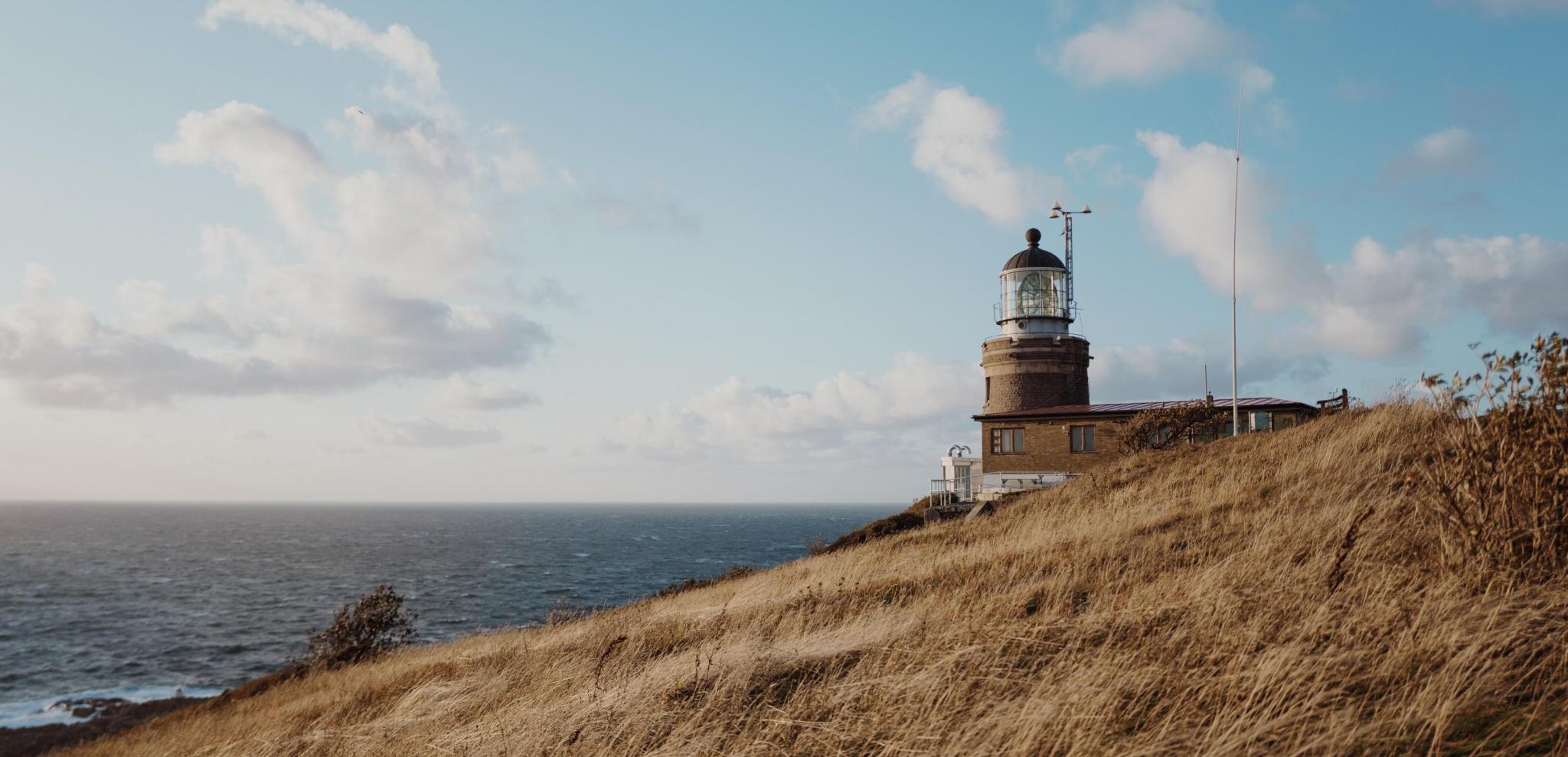  A lighthouse up on a hill facing the sea at Kullaberg