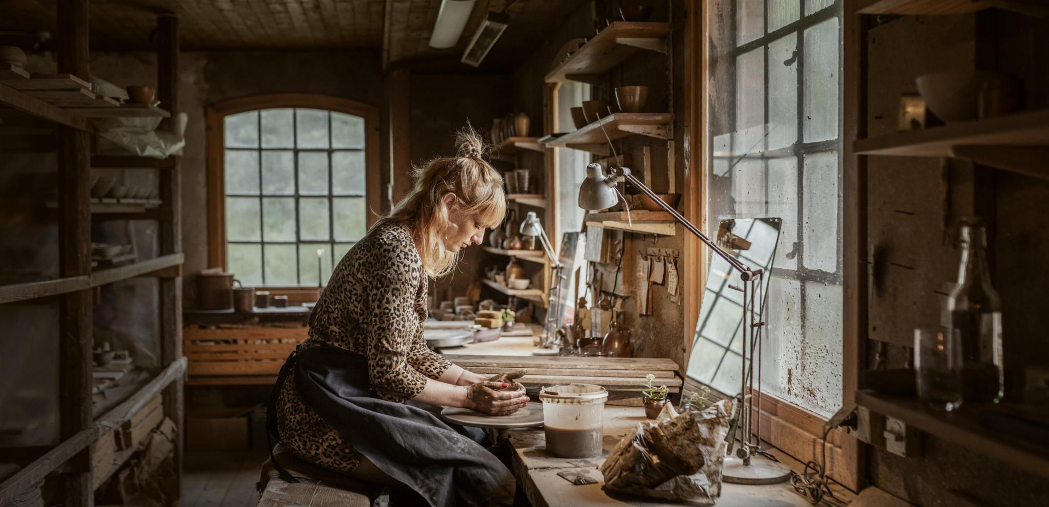 A woman turning pottery at Wallåkra Stoneware factory