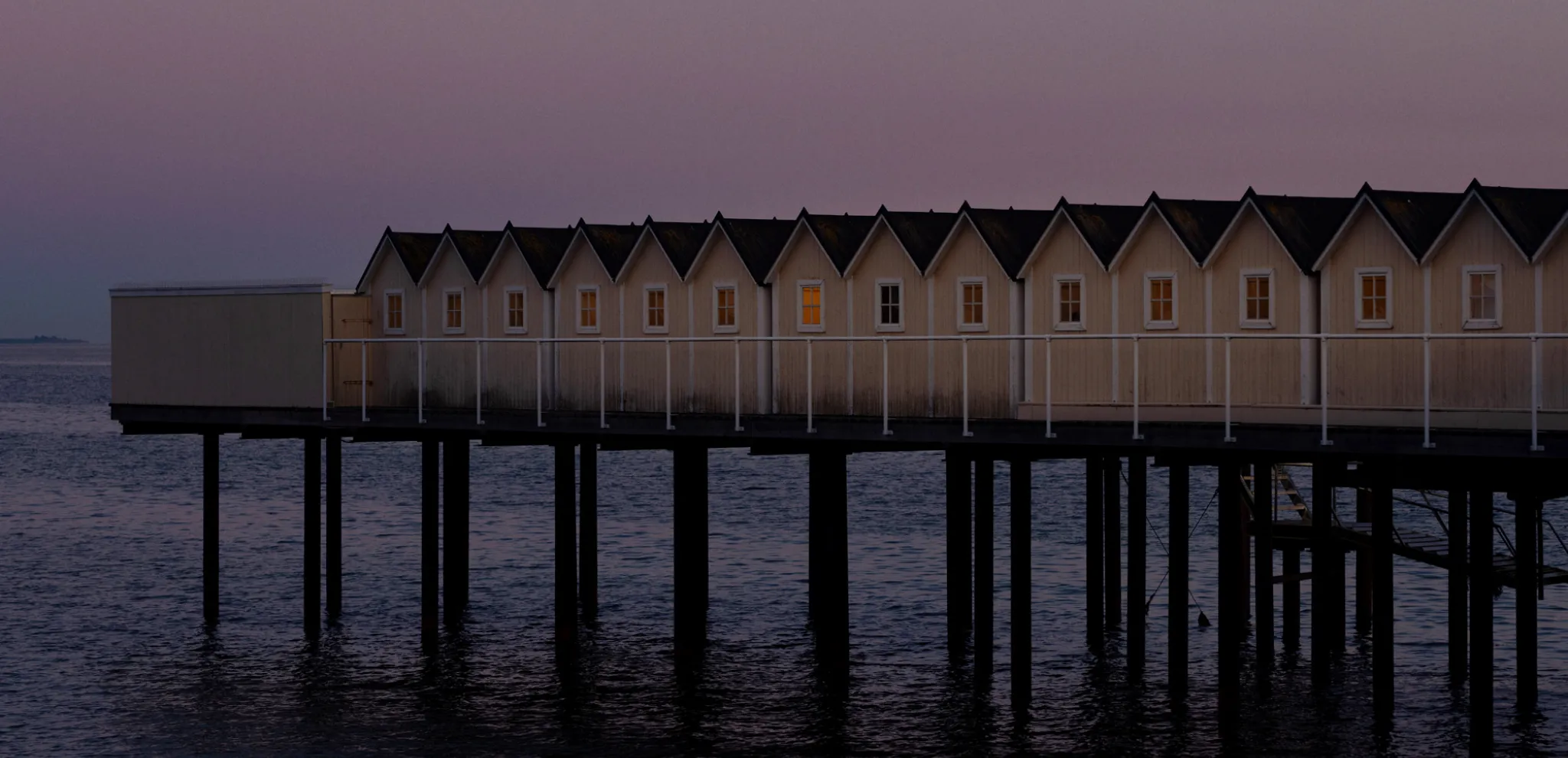 Huts in a row in sunset
