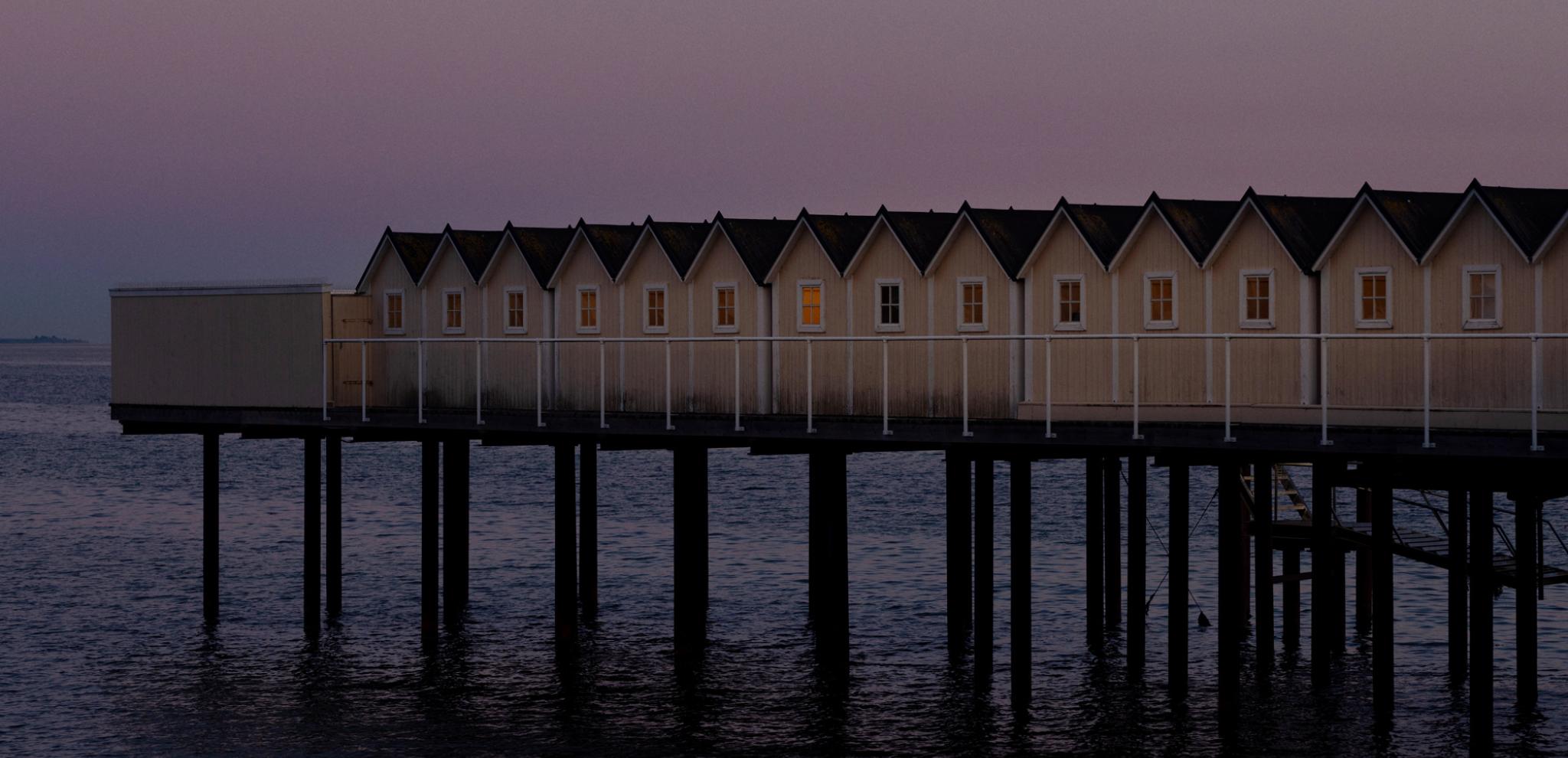 Huts in a row in sunset