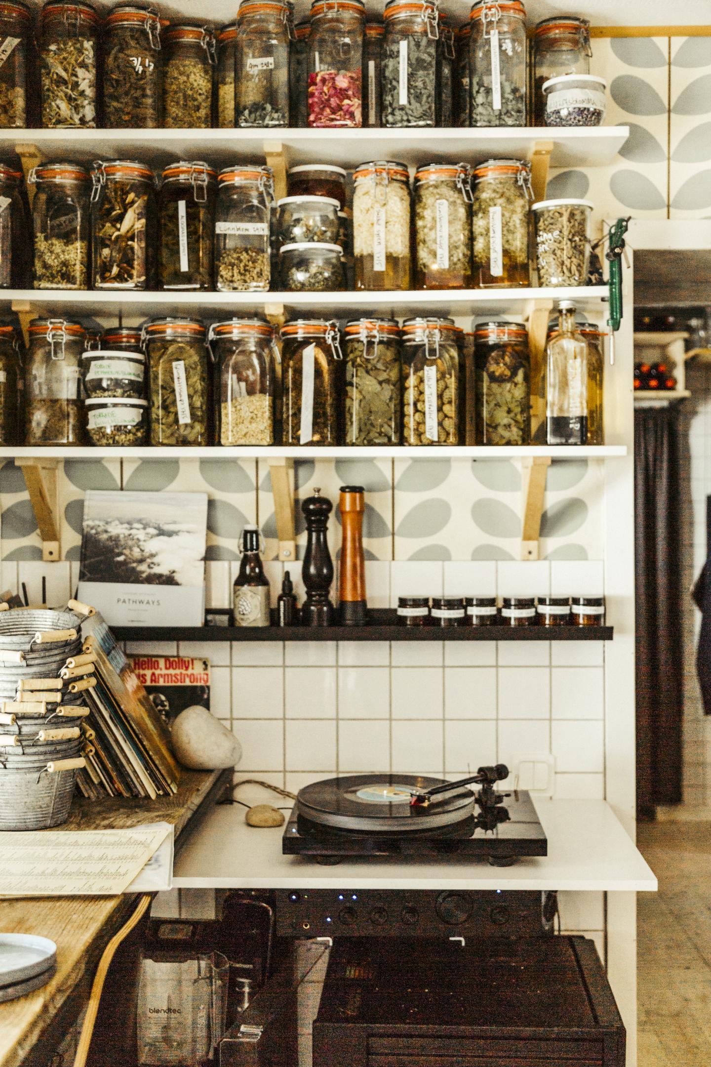 Wall with jars filled with dry food and counter