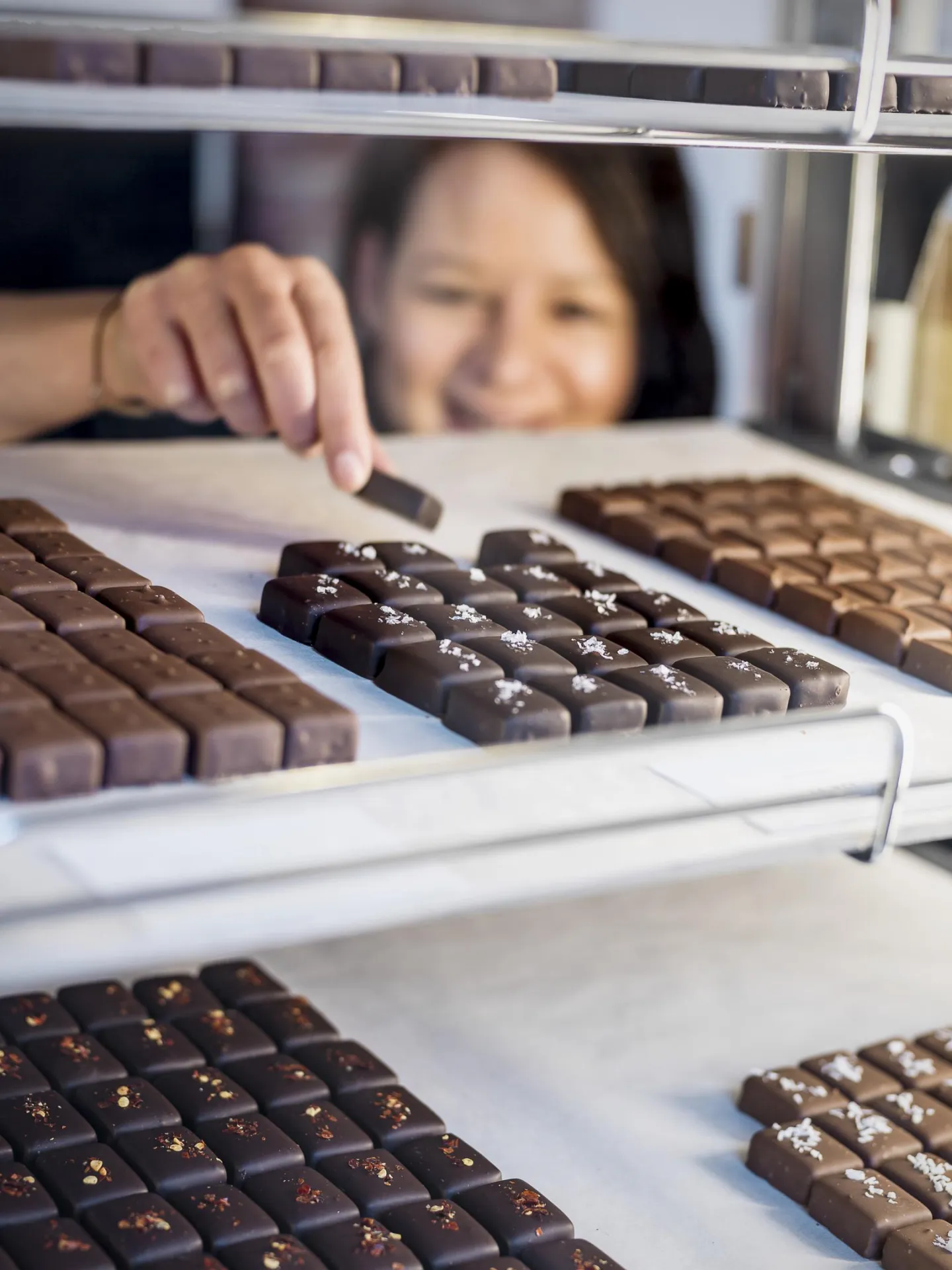 Personnel taking pralines from display counter