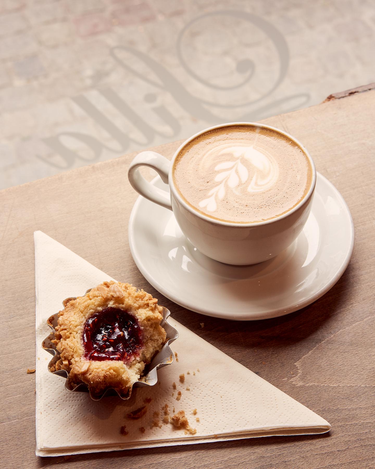 Danish pastry on serviette with cappucino