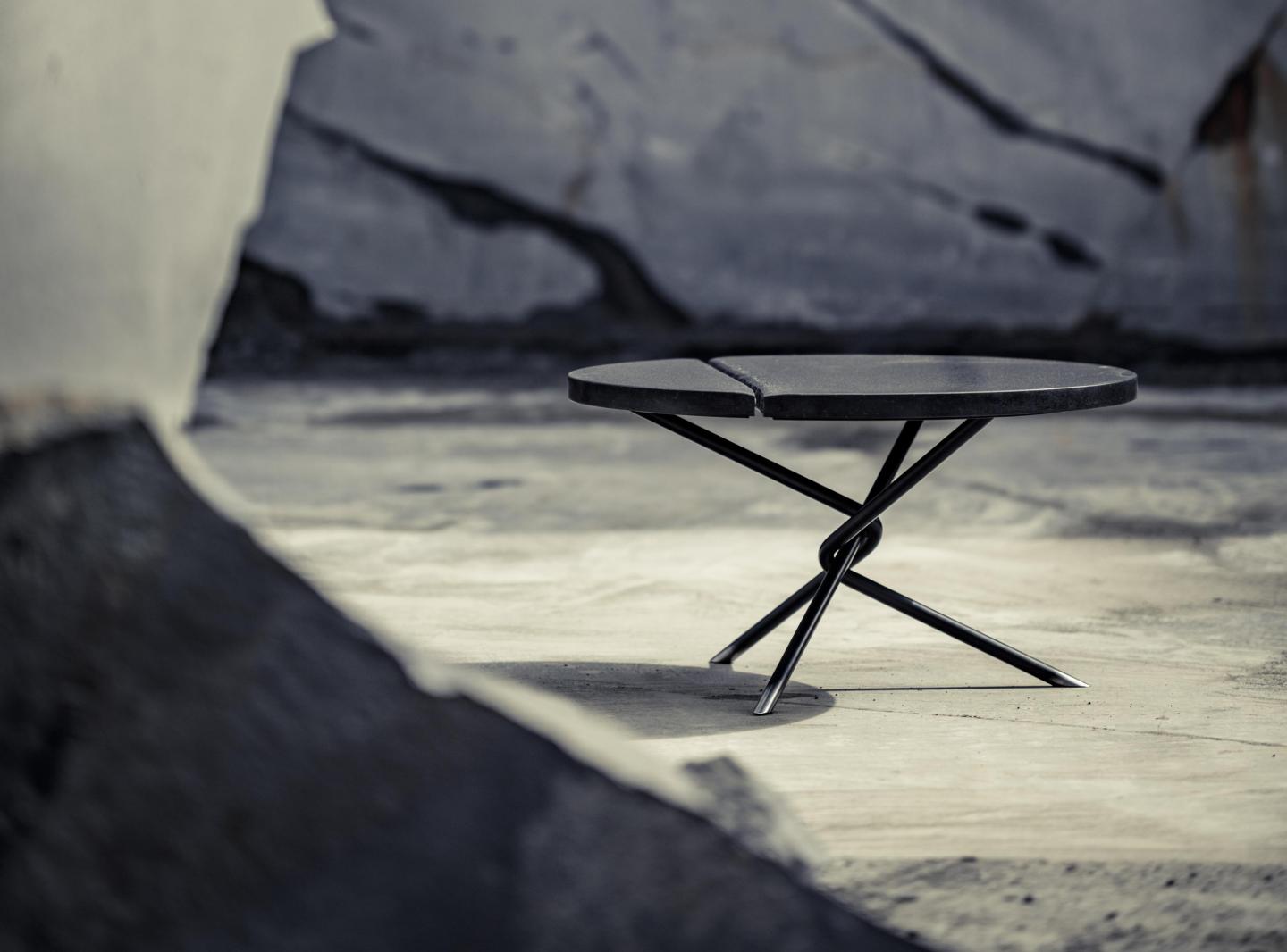 Balck coffee table surrounded by cliffs