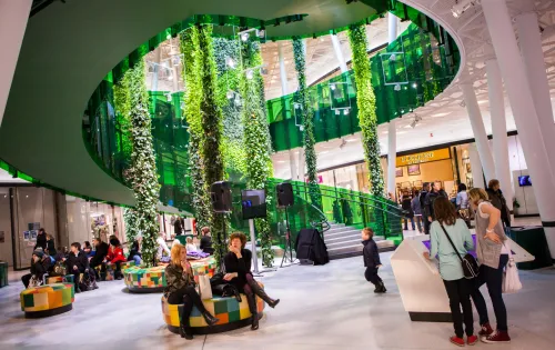 People and a spiral staircase inside Emporia shopping center Malmö