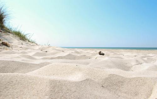 A white sandy beach at Sandahmmar on a clear summer day 