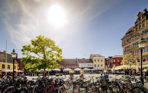 Bicycles parked at Lilla torg in Malmö on a sunny summer day 