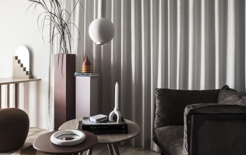 Hotel apartment environment with a sofa, coffee table, and decor