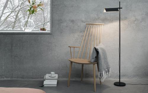 Grey room with rocking chair, blanket and a floor lamp
