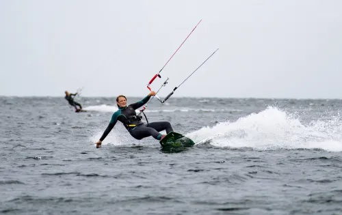 Woman kite surfing on water