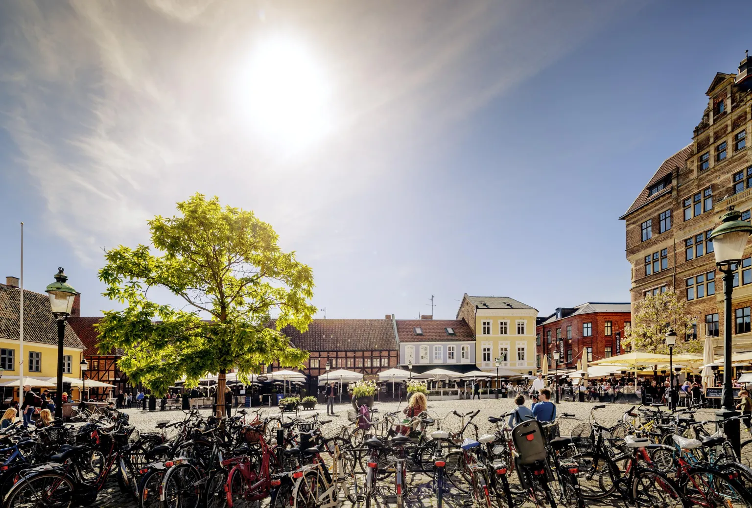 Bicycles parked at Lilla torg in Malmö on a sunny summer day 