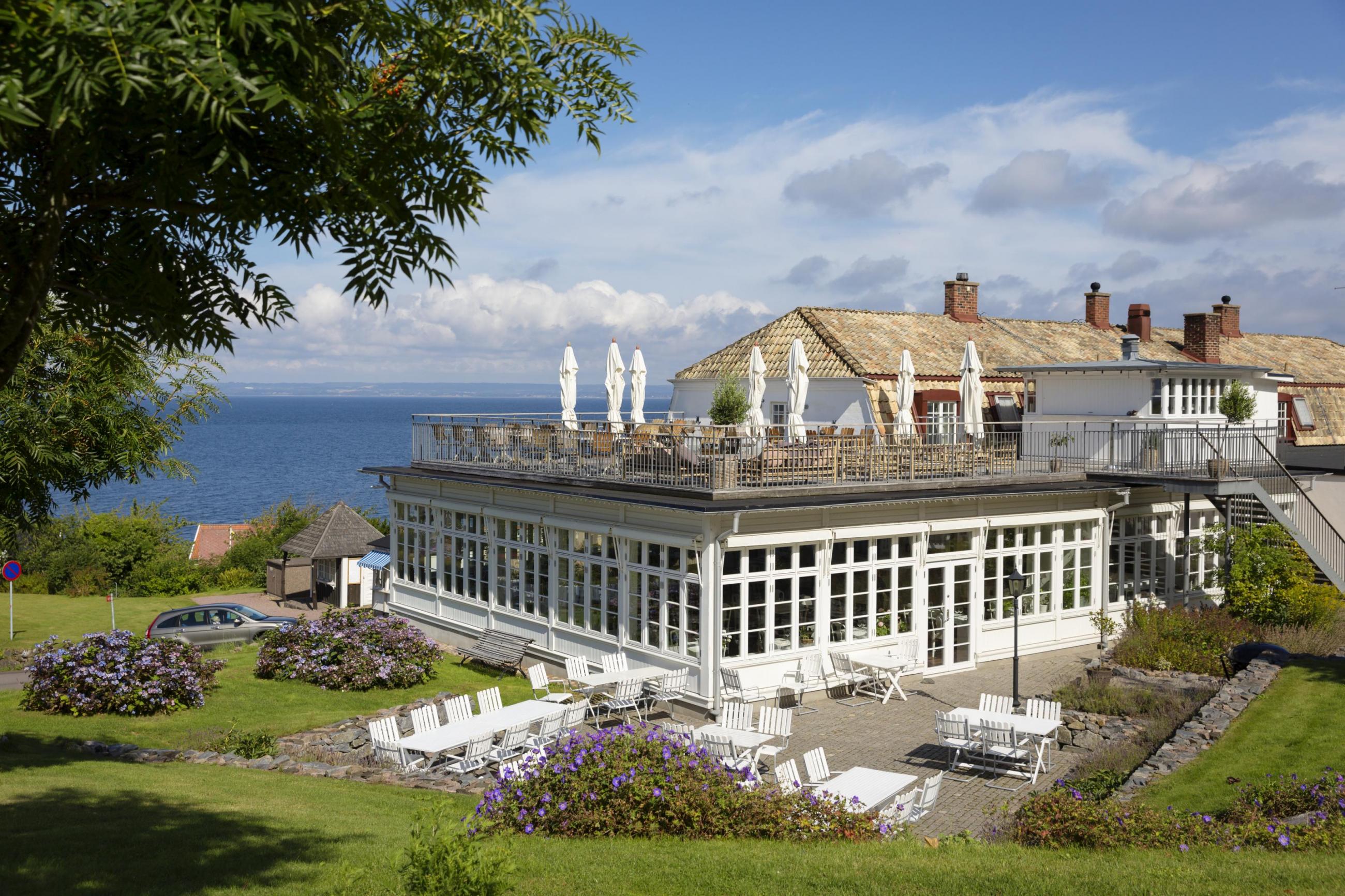 Utsikt över Rusthållargårdens hotell med havet i bakgrunden vid Kullaberg