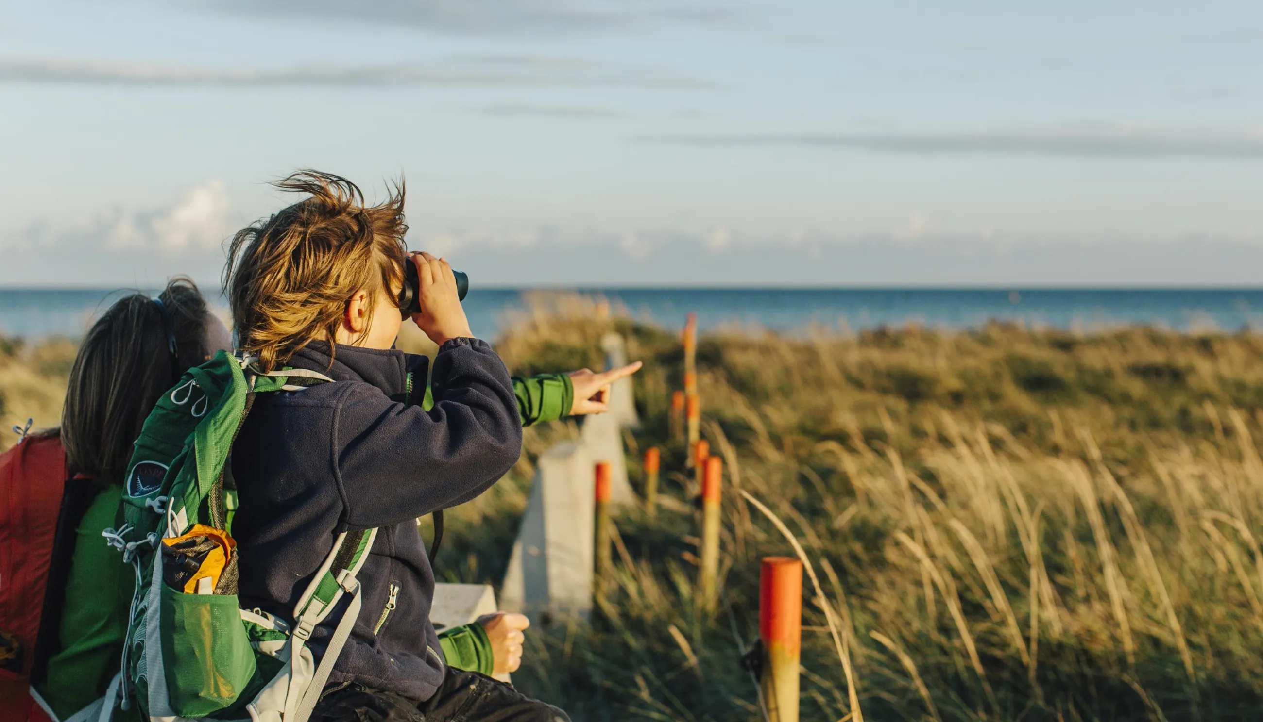 Mother and son gazing through binoculars in Måkläppen