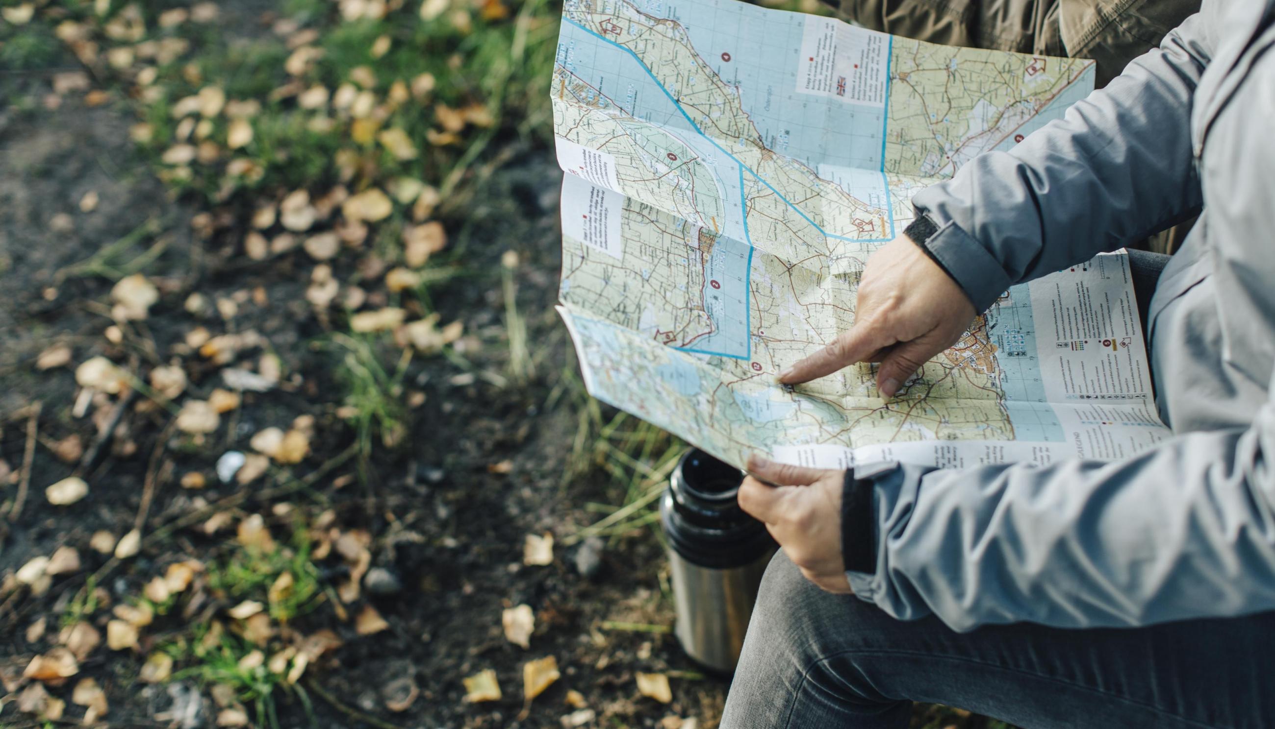 hand up close pointing at a map