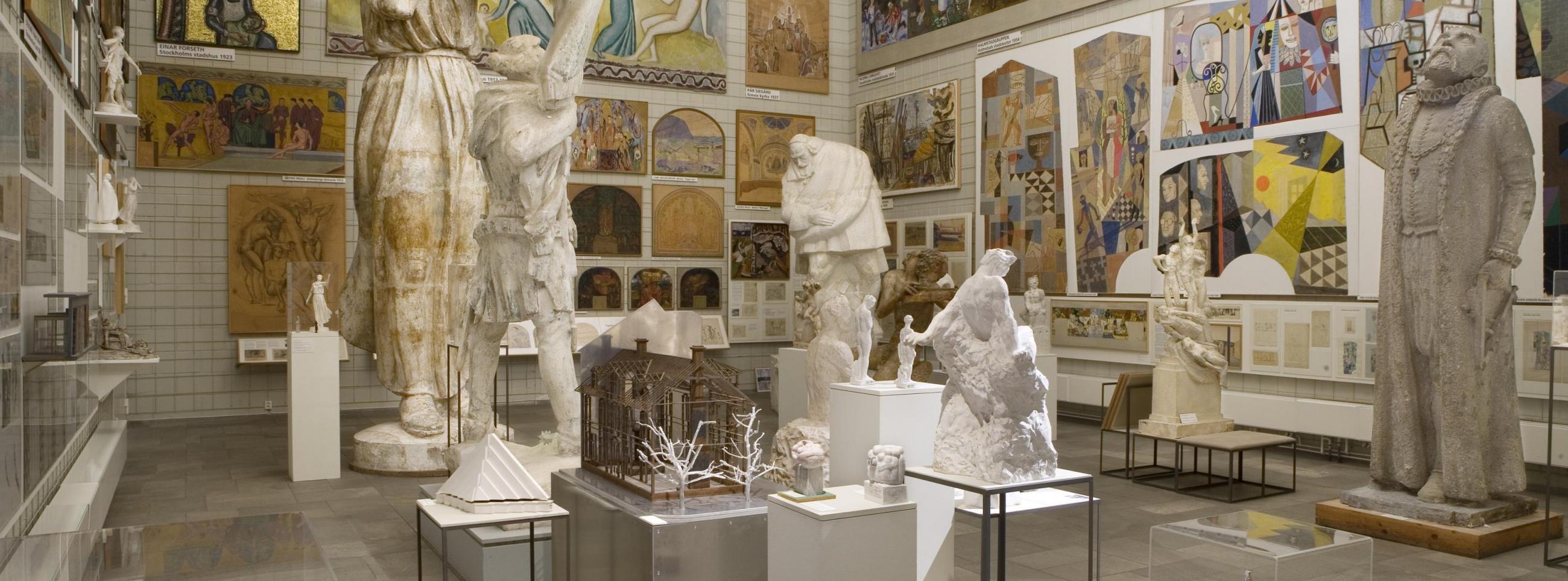 A room covered with painting and large antique sculptures at Skissernas museum