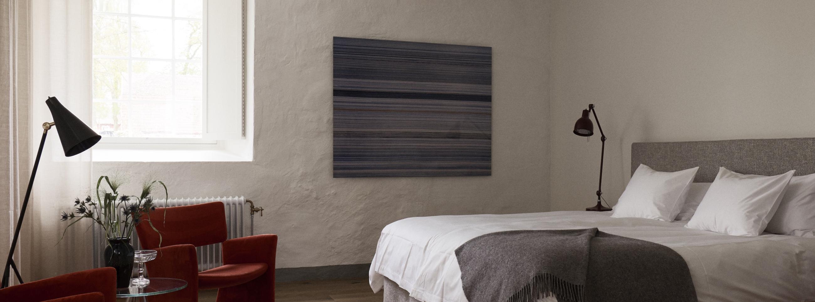 hotel room with a bed, design furniture and plastered walls?