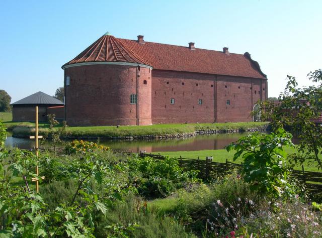 Red citadel with a green garden in front