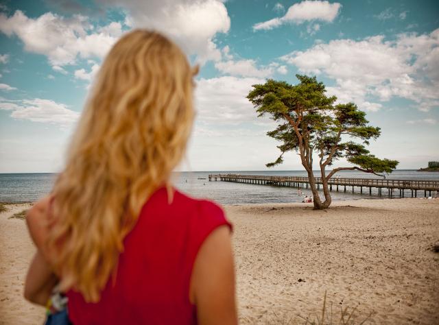 Woman facing the beach at Täppet in Åhus 