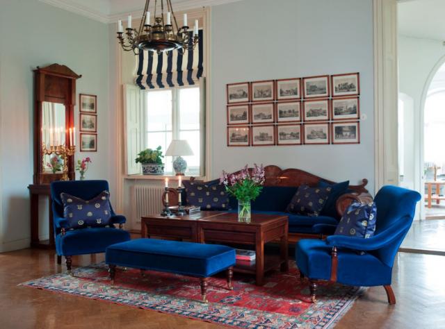 Living room environment with a blue sofas and red carpet