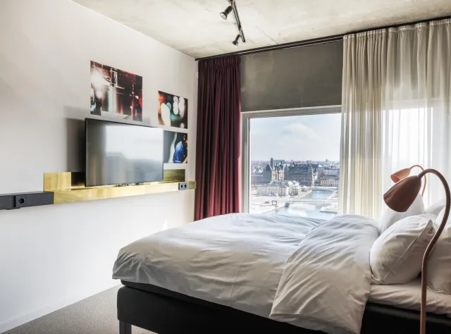 Hotel room with bed and flatscreen television big window view