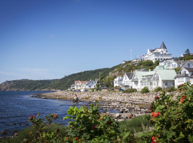 A view from a far of the picturesque coastal village of Mölle with sea views and forests