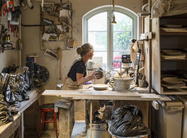 Woman making pottery in ceramicstudio