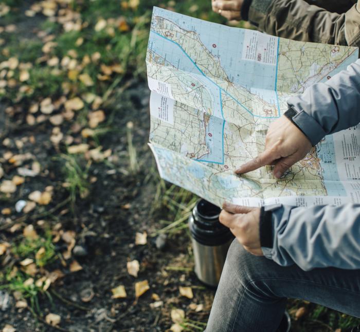 person poiting at a map