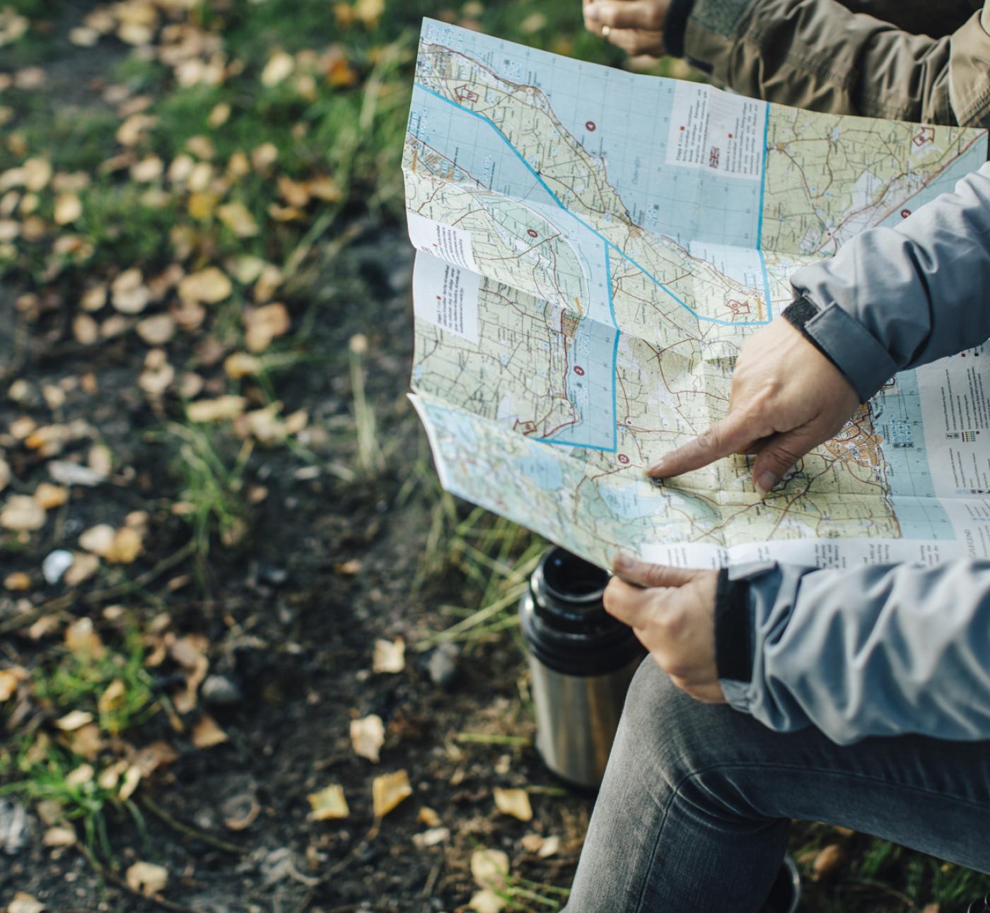 person poiting at a map