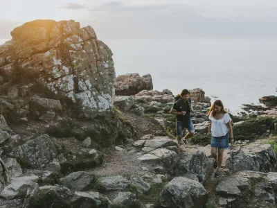 A couple Hiking among the rocks by the sea in hovs hallar