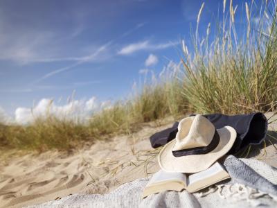 Two women walking on the sandy beach in summer