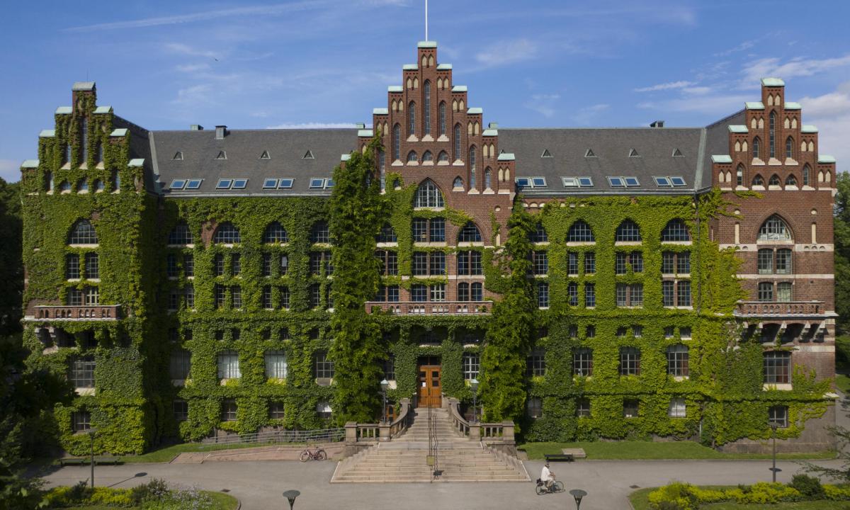 Historic library building facade covered in green ivy, creating a charming architectural scene
